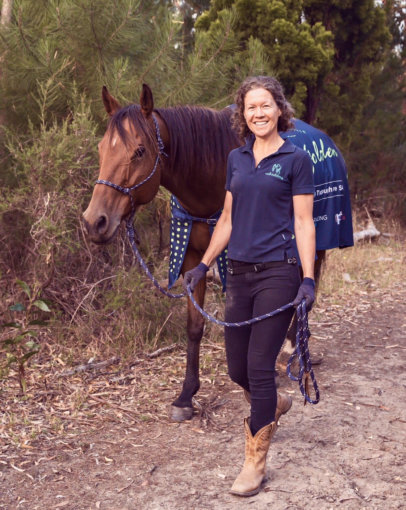 Lady and a horse on the trail not horse riding but walking together